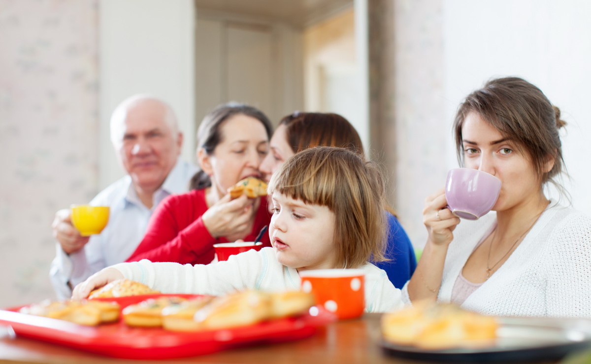 happy multigeneration family communicate around tea table